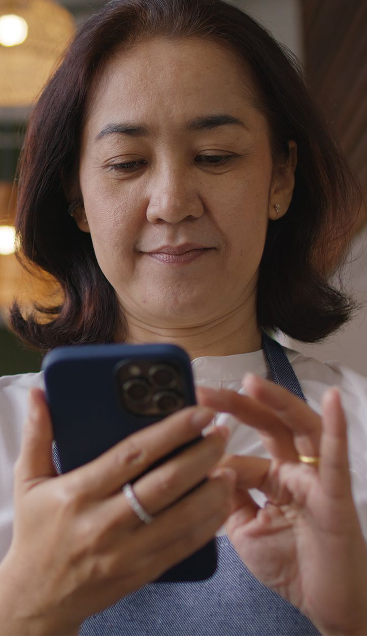 Local team member managing SMS replies from phone